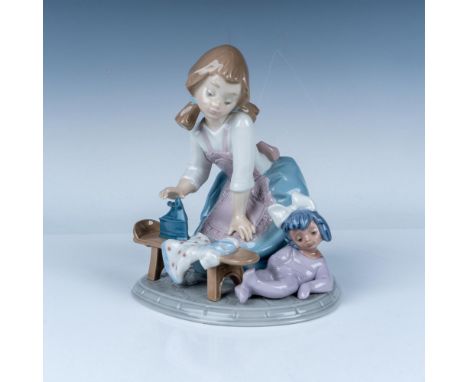 This delightful Lladro porcelain figurine, titled My Chores (No. 5782), depicts a young girl carefully ironing her doll's dre