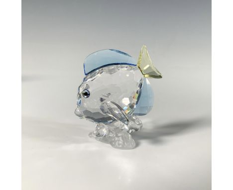 A stunning crystal figure, showcasing a detailed fish in clear, blue, and yellow hues, perched atop a frosted coral base. SCS