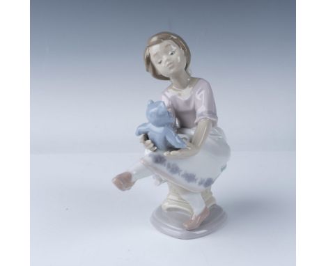 This porcelain figurine by Lladro, titled Columpiando al Osito (Best Friend), portrays a young girl seated on a swing, gently