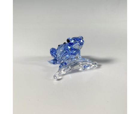 A small facet-cut blue crystal figure of a frog perched on a leaf, adorned with black gemstones. A limited edition item avail