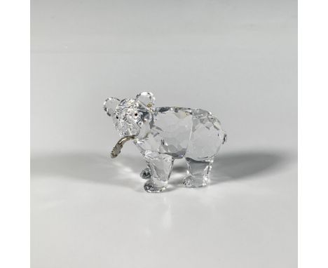 A multi-faceted crystal figure with smooth features of a cub, holding a metal fish in its mouth. Part of the Rare Encounters 