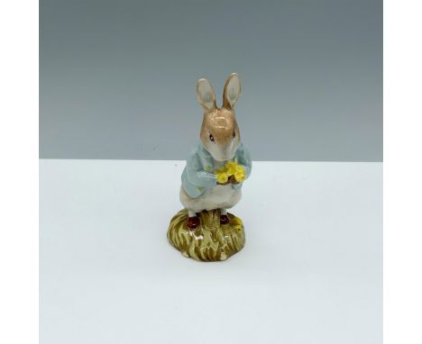 Glossy porcelain figure of a rabbit with a jacket as he holds flowers. Beswick, Beatrix Potter, F Warne and Co, and Royal Dou