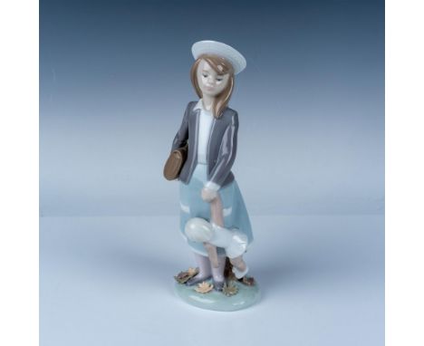 A delightful Lladro porcelain figurine titled Autumn Girl with Doll (Model 5218), depicting a young girl in soft pastel tones