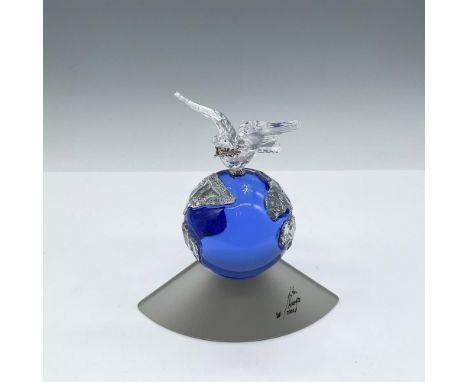 Cobalt blue crystal globe with clear crystal continents shown. Bird of peace, dove, holding an olive branch perched on top. S