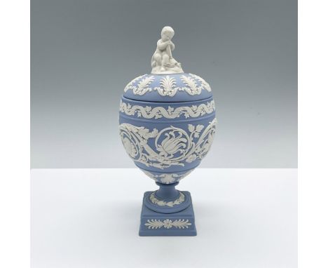 A beautiful blue urn-shaped vase with a round decorative lid and square base. The English pottery is adorned with floral blue