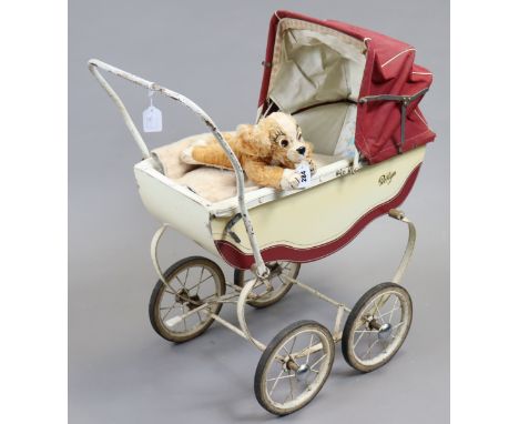 A vintage Merrythought ‘Lady’ (Lady &amp; The Tramp) soft toy, 31cm long; a vintage Roslyn dolls pram, 74cm long; together wi
