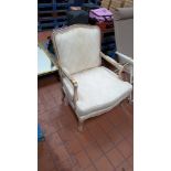 Upholstered chair and what is understood to be solid carved wood. The arms need re-upholstering