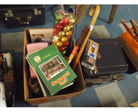 A Box Containing Walking Stick, Tennis Racket, Books, Christmas Baubles, Wheeled Travelling Case, Paint Brushes Etc 