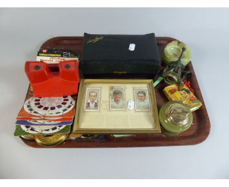 A Tray of Curios to Include View Master with Stereo Reels, Powder Compact, Framed Cricket Cigarette Cards, Playing Cards Etc