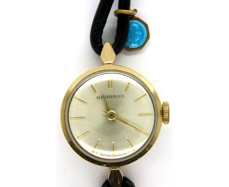 Garrard: 9ct gold cased ladies wristwatch, working at lotting up, leather strap damaged. P&amp;P Group 1 (£14+VAT for the fir