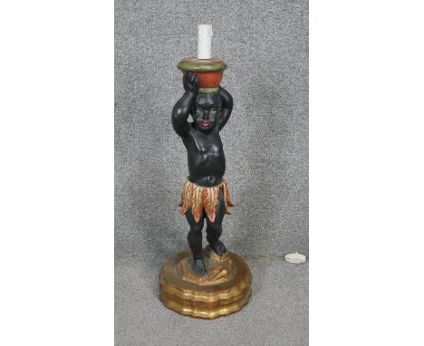A carved painted and gilded wooden blackamoor table lamp. H.60cm 