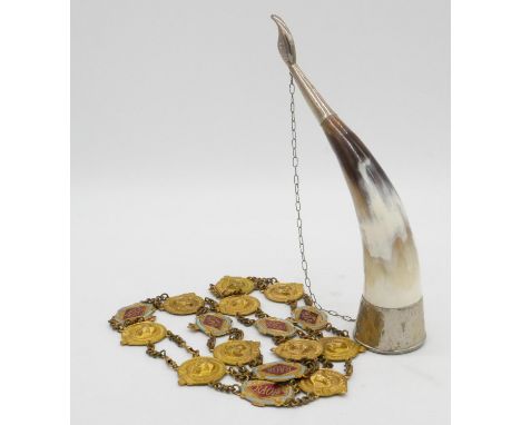 A white metal drinking horn and a Royal Antediluvian Order of Buffaloes belt with gilt metal and enamel panels. H.25cm 