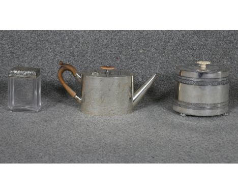 A cut glass dressing table jar with embossed English hallmarked silver top along with a 19th century silver plated tea pot an