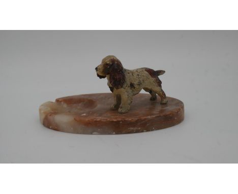 A vintage marble ashtray with a cold painted figure of a spaniel. 