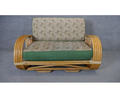 A vintage Continental bamboo sofa in its original floral upholstery. H.80 W.123 D.100cm 