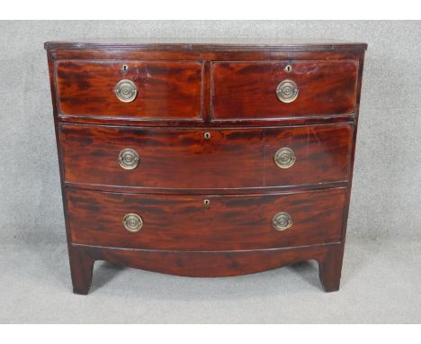 A Georgian mahogany bow fronted chest of drawers with brass plate handles on shaped bracket feet. H.94 W.105 D.50cm 