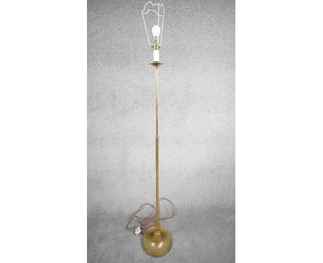 A vintage solid brass candle design height adjustable standard lamp with ridged circular base. With silk wrapped cord and thr