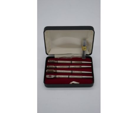 A cased set of silver and enamel bridge marker/pencils with spare leads. Stamped Sterling Silver. 