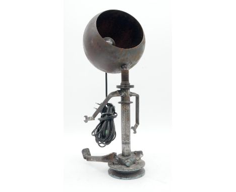 An industrial table lamp in the form of a seated figure with shade for the head. H.45cm 