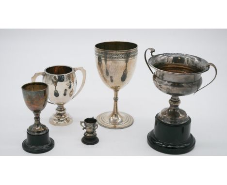 A collection of five silver trophy cups. Three on wooden and plastic bases. Various British hallmarks. Weight 287g 