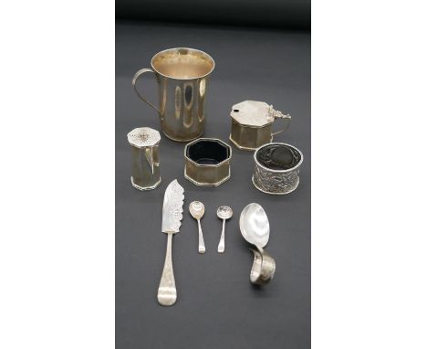 A collection of antique silver. Including a hammered silver tankard, two silver napkin rings, a silver caddy spooon, two silv