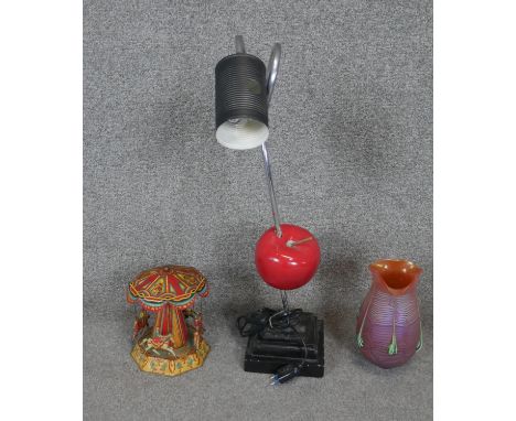 A collection of curiosities. Including a floating apple vintage desk light, a Loetz style orange Art Glass vase with veining 