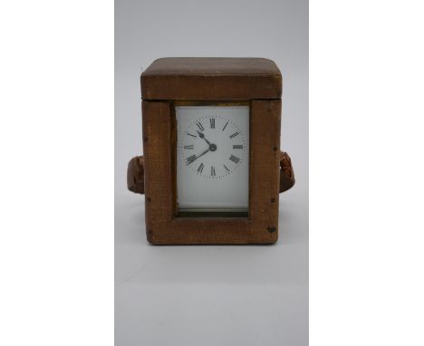 A 19th century leather cased French brass carriage clock with glass plates. H.13 W.10 D.9cm 