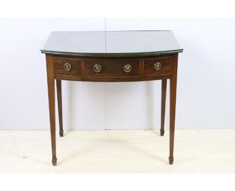 Mahogany antique bow fronted console table with three drawers supported on square tapering legs with glass topper, H 72cm, W 