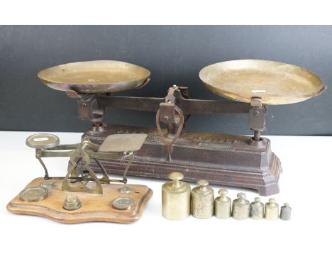 Two sets of weighing scales, larger example with brass dishes and weights set on cast iron base, Force 10 kilogram, smaller e