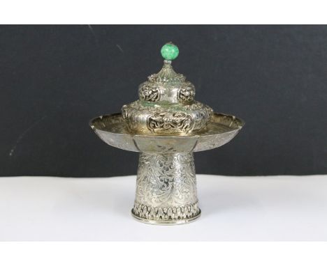 A Chinese / Tibetan silver / white metal cup stand and lid with fine chased decoration, stands approx 14cm in height.