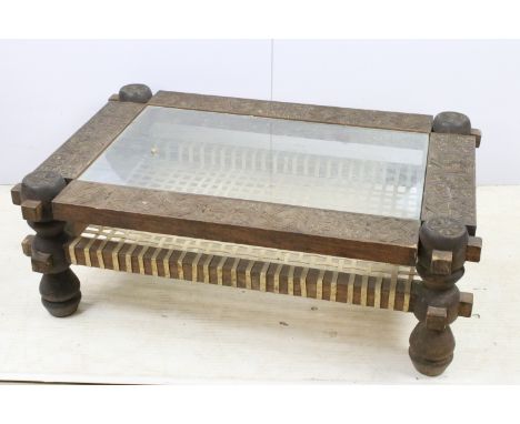 Hardwood&nbsp;Ethiopian intricately carved tile pattern coffee table with round end supports, glass top and lattice work stra