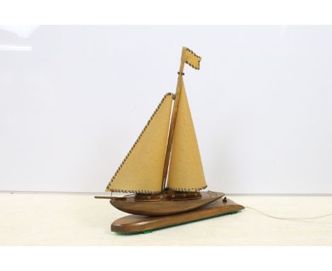 Art Deco table lamp in the form of a boat of wooden construction with two hide sails and flag, measures H 50cm, W 44cm