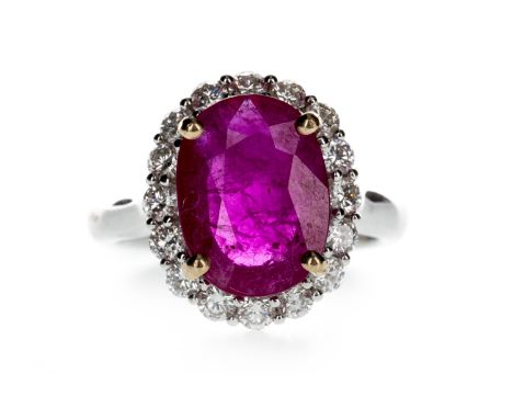 RUBY AND DIAMOND RING, set with an oval ruby of approximately 3.76 carats within a halo of round brilliant cut diamonds total
