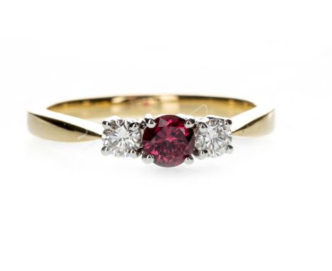 RUBY AND DIAMOND THREE STONE RING, the round ruby flanked by two round brilliant cut diamonds totalling 0.25 carats, in eight