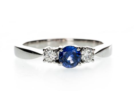 SAPPHIRE AND DIAMOND THREE STONE RING, the round blue sapphire flanked by two round brilliant cut diamonds totalling approxim