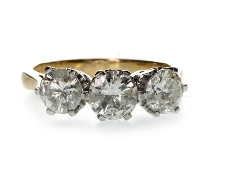 DIAMOND THREE STONE RING, set with a central round brilliant cut diamond of approximately 0.76 carats flanked by two smaller 