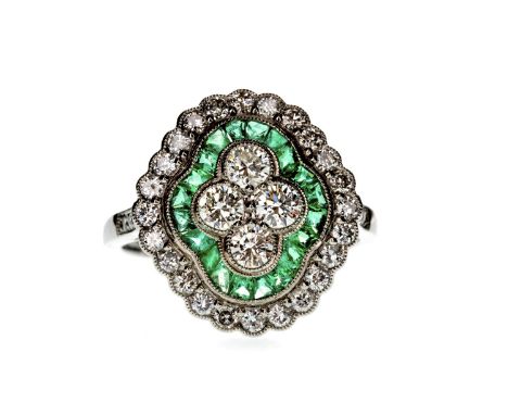 EMERALD AND DIAMOND RING, with four central round brilliant cut diamonds within a border of calibre cut emeralds, in turn bor