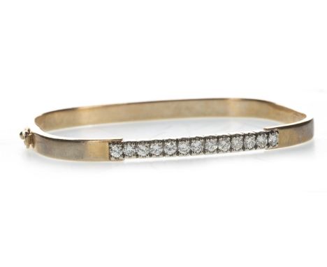 DIAMOND SET BANGLE, set with a row of round brilliant cut diamonds totalling approximately 0.65 carats, unmarked, 16.7g