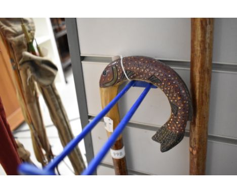 A walking stick with carved fish handle