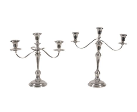  Two American weighted silver coloured three light candelabra by Cartier, stamped marks,   in the neoclassical style, the fix