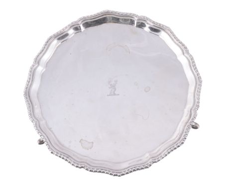  A silver shaped circular salver by S. W. Smith  &  Co.,   Birmingham 1928, on three pad feet, engraved with a stag's head cr
