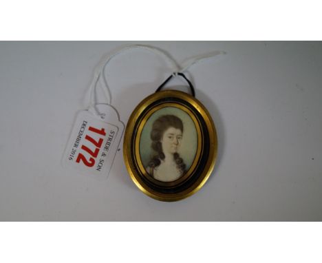 English School, late 18th century, head and shoulders portrait miniature of a lady, 4.4 x 3.3cm oval, in a verre eglomise fra