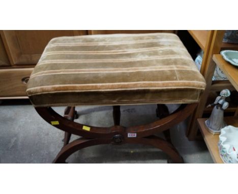 An antique mahogany X frame stool.  Condition Report: Commensurate with age and use, joints are firm. No sign of worm seen.