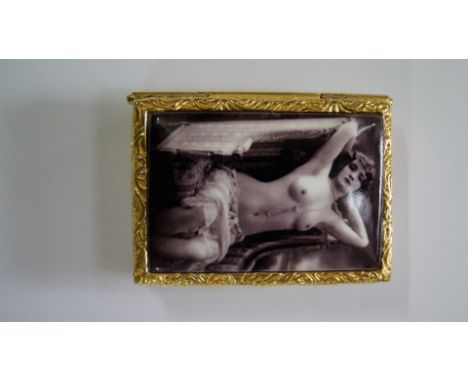 An 18ct gold plated snuff box, the hinged top decorated in enamel with a nude, 5cm wide.