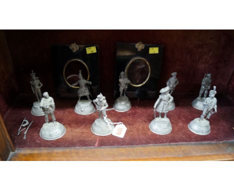 A set of nine Charles C Stadden pewter military figures, 11cm high; together with a pair of Victorian ebonized miniature port