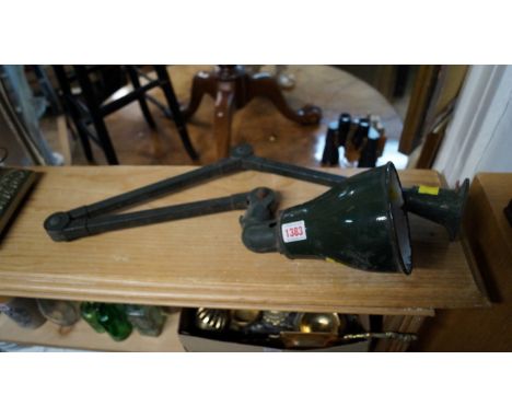 A vintage green painted articulated industrial lamp. Condition Report: The lamps holds its shape when moved to different angl