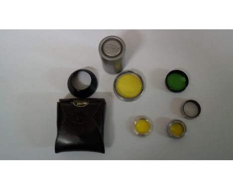A small quantity of camera related items, to include filters; a vintage Leica aluminium film canister; a Leitz brass film spo