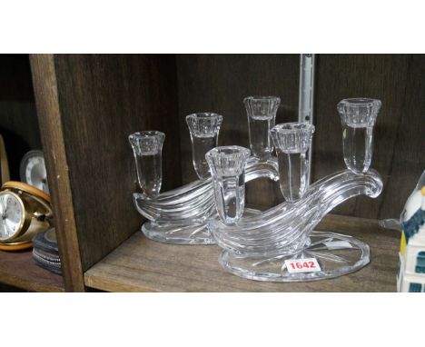 A pair of clear glass three light candelabra, 16cm high. 