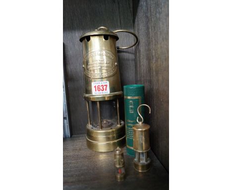 A British Coalmining Company brass lamp; together with two further miniature examples, one boxed. 