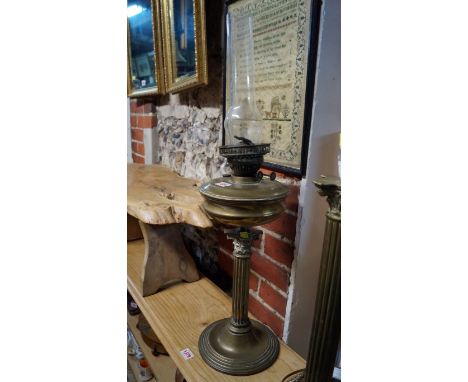 A brass Corinthian column oil lamp, height excluding chimney 48cm. 